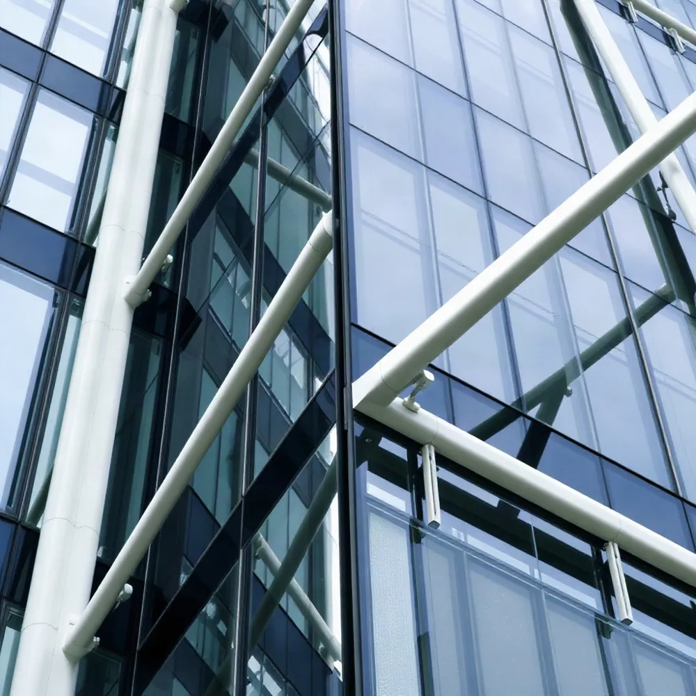 Engineers must specify heat-treated glass and site-specific access systems to manage the intense wind pressures and thermal expansion cycles inherent to Middle Eastern high-rise design.