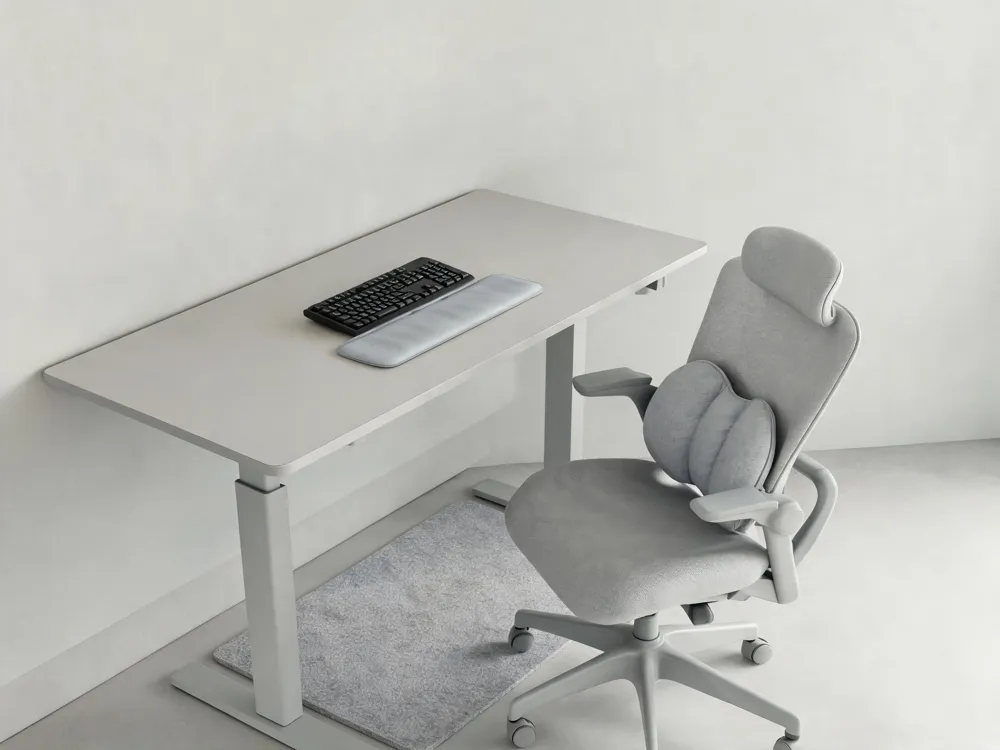 An adjustable ergonomic chair with lumbar support, a standing desk, a gel wrist rest, and an anti‑fatigue mat, emphasizing comfort for long work sessions.