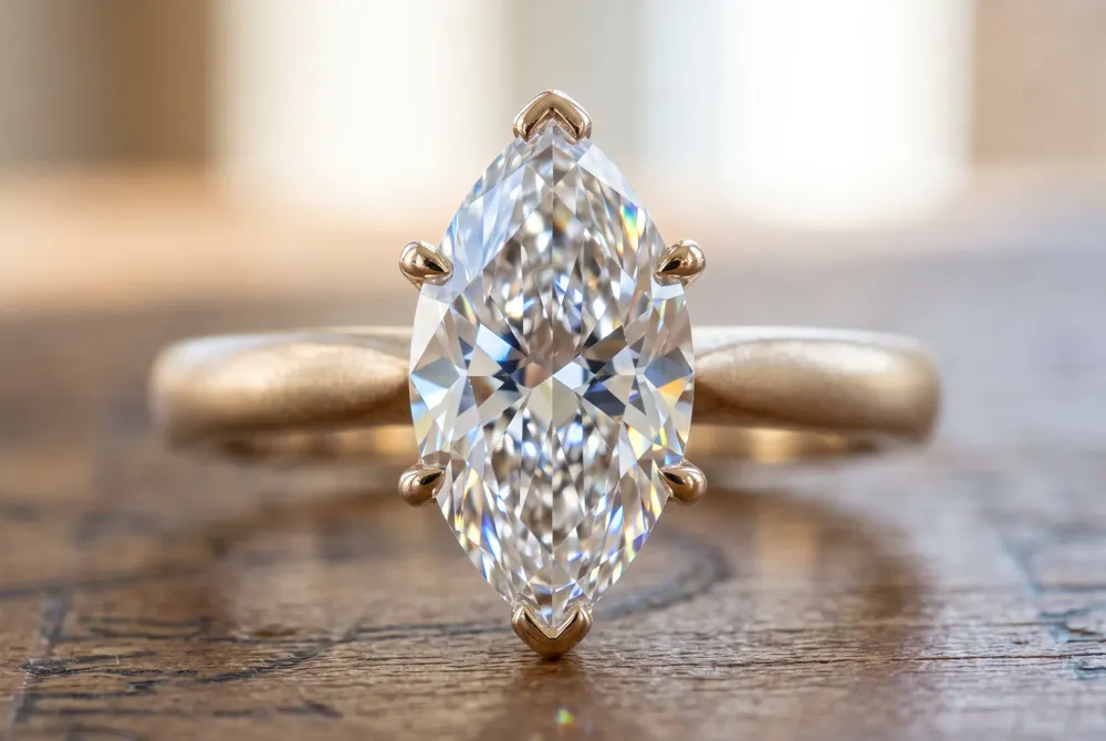 A well-cut marquise diamond with flawless symmetry delivers far more brilliance than a stone with higher clarity but poor proportions, making cut the most critical choice for your ring.