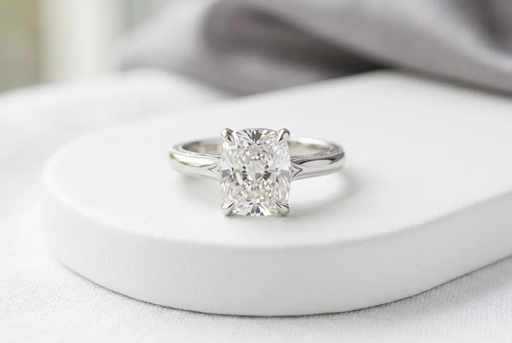 A softly elongated cushion offers a polished silhouette with room to personalize the setting and band.
