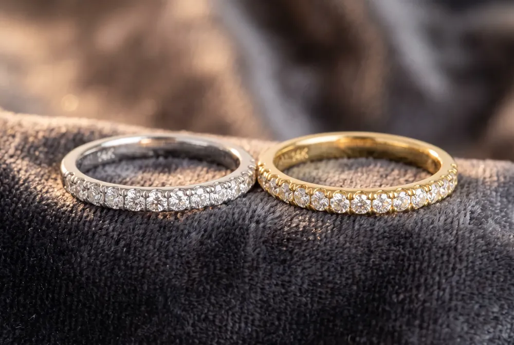 Travis Kelce's substantial 18K yellow gold band complements Swift's delicate ring through shared metal and finish while expressing his own distinct style.