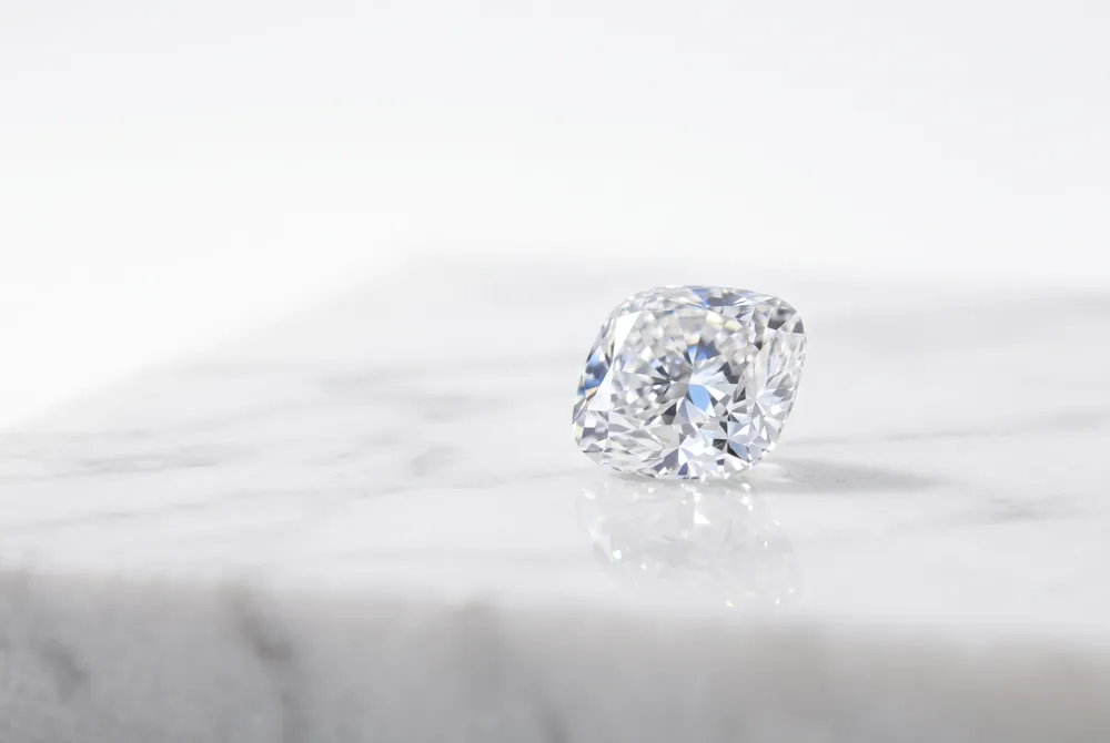 Discover the timeless sophistication and soft geometry of the cushion cut, a shape that masterfully blends vintage charm with modern brilliance.