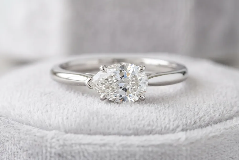An east-west orientation turns your pear diamond horizontally, making a bold style statement that enhances its visible size and creates a striking silhouette.