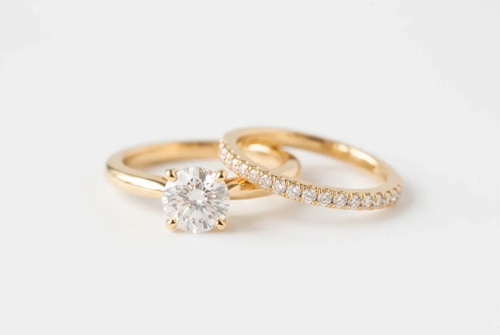 The contoured half-eternity band of Taylor Swift’s wedding ring nestles flush against her engagement ring, blending beauty with practical everyday wear.