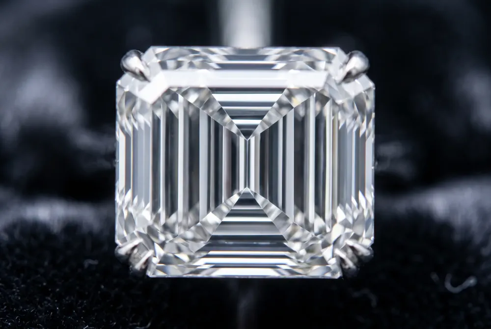 The emerald cut's long, parallel step facets create a hall-of-mirrors effect that channels the geometric sophistication of Art Deco design.