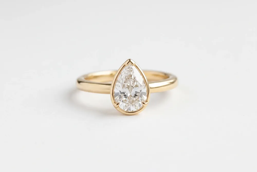 Pear-shaped diamonds offer a graceful teardrop silhouette that flatters the finger and provides exceptional value with its elongated profile.