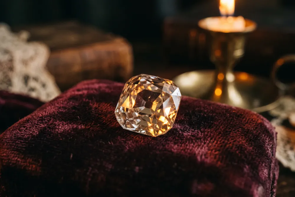 Discover the antique charm of an old mine cut diamond, hand-crafted with chunky facets and a visible culet for a romantic, candlelit glow.
