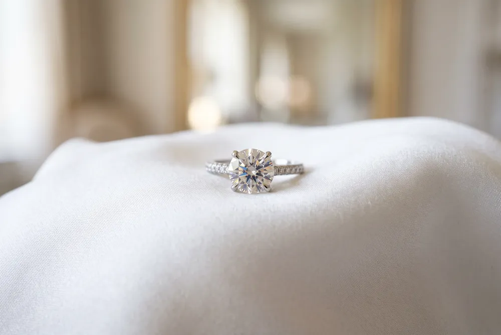 Amplify the innate fire of your cushion cut moissanite with a luminous halo setting designed for maximum brilliance.