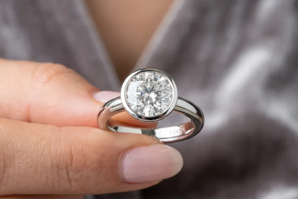 The bezel setting encases the pear diamond in a smooth metal rim for unmatched security against chips and snags, creating a sleek, modern silhouette ideal for active lifestyles.