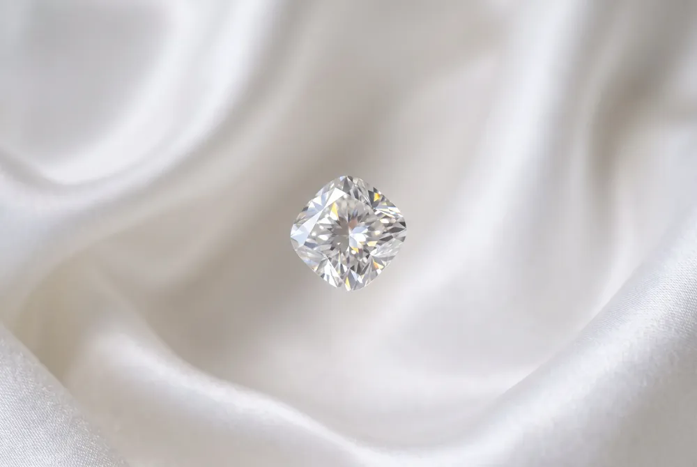 For a cushion cut moissanite, cut quality comes first, followed by careful consideration of color grade and clarity to ensure enduring brilliance.