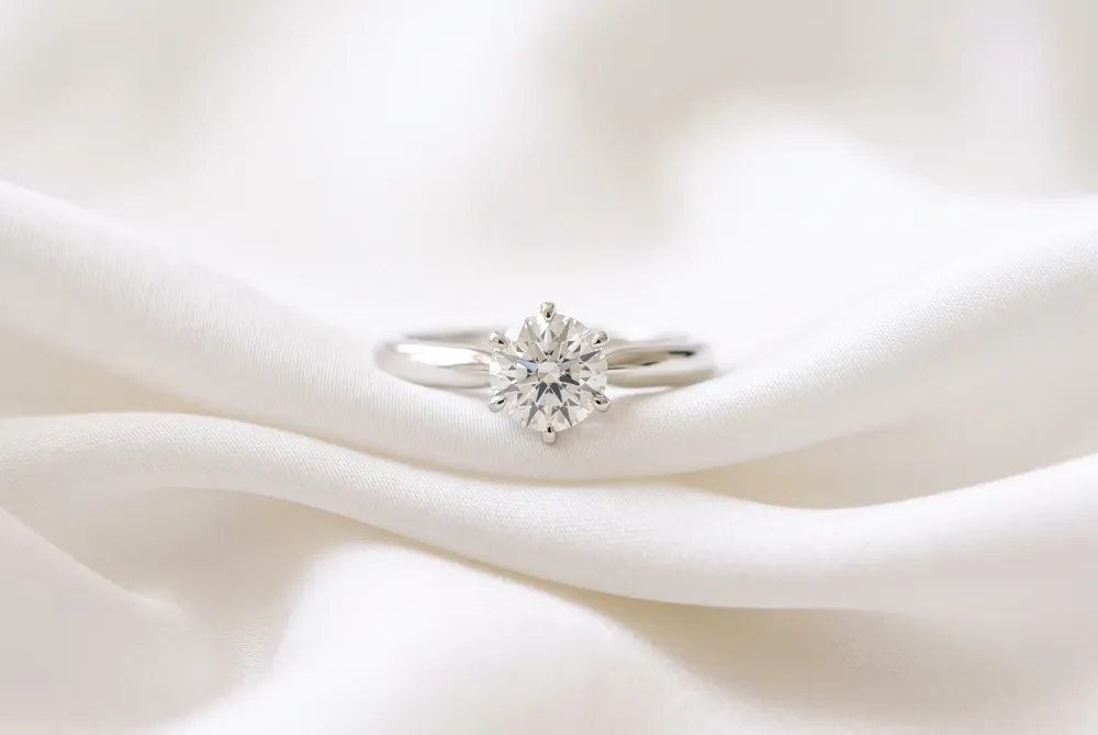 Embrace the understated luxury of a solitaire setting that allows your elongated cushion cut stone to take center stage with timeless grace.