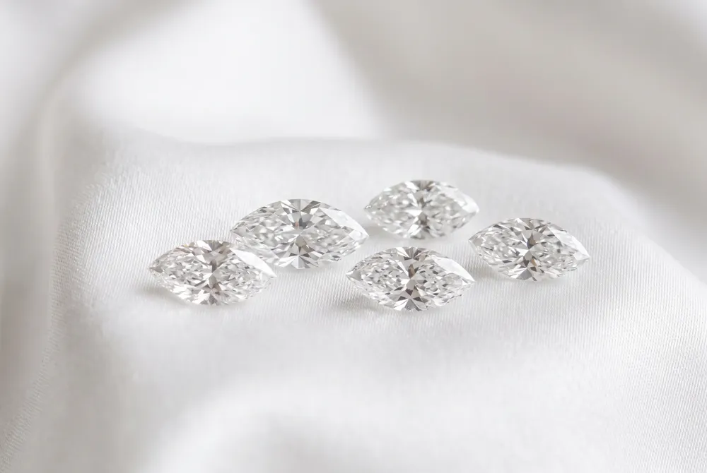 The marquise cut is an elongated diamond shape with curved sides and two pointed ends, known for its finger-lengthening effect and regal 18th-century French origins.