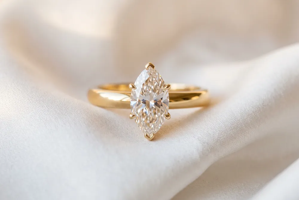 Intricate filigree and the warmth of yellow gold imbue the marquise cut with a romantic, heirloom quality that honors timeless artistry.