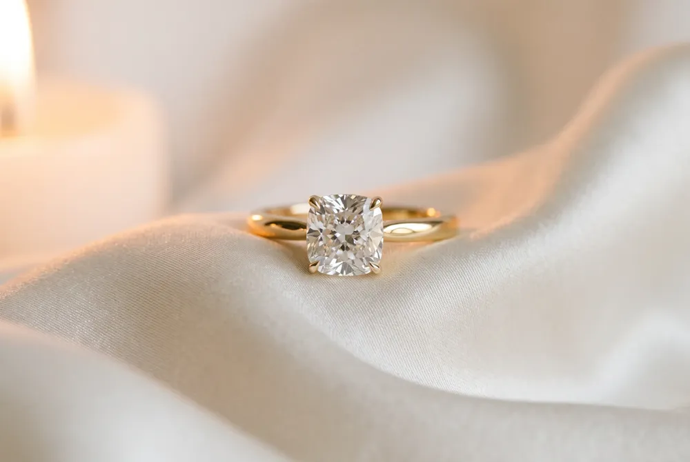 The cushion cut's soft, pillow-like outline and broad facets create a romantic, understated glow that harks back to candlelit evenings.