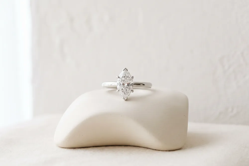 Set horizontally across the finger, a marquise solitaire offers a fresh profile while keeping attention on the center stone.