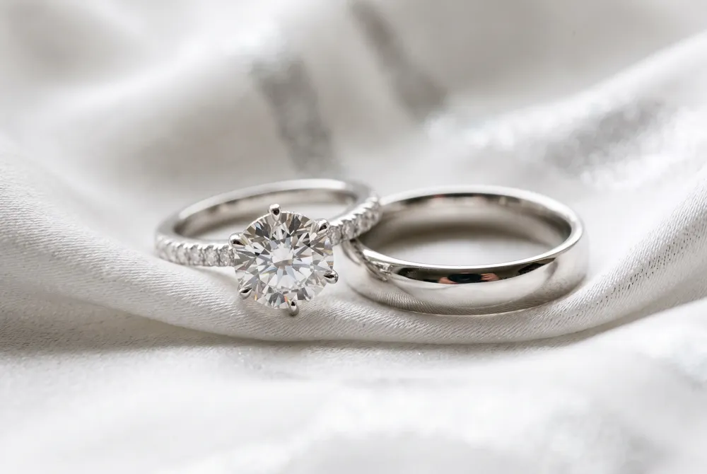 The engagement ring commands a higher investment due to its center diamond and craftsmanship, while the wedding band offers enduring beauty at a more accessible cost.