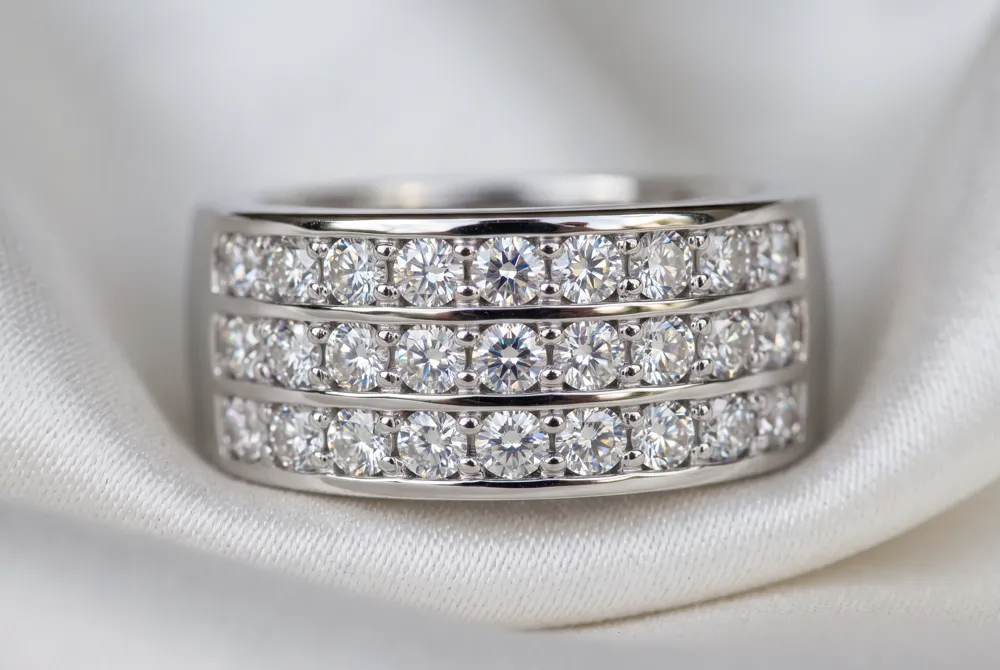 Multi-row eternity bands feature two or three parallel rows of stones for a wider, more substantial look that commands attention and functions beautifully as a standalone statement piece.