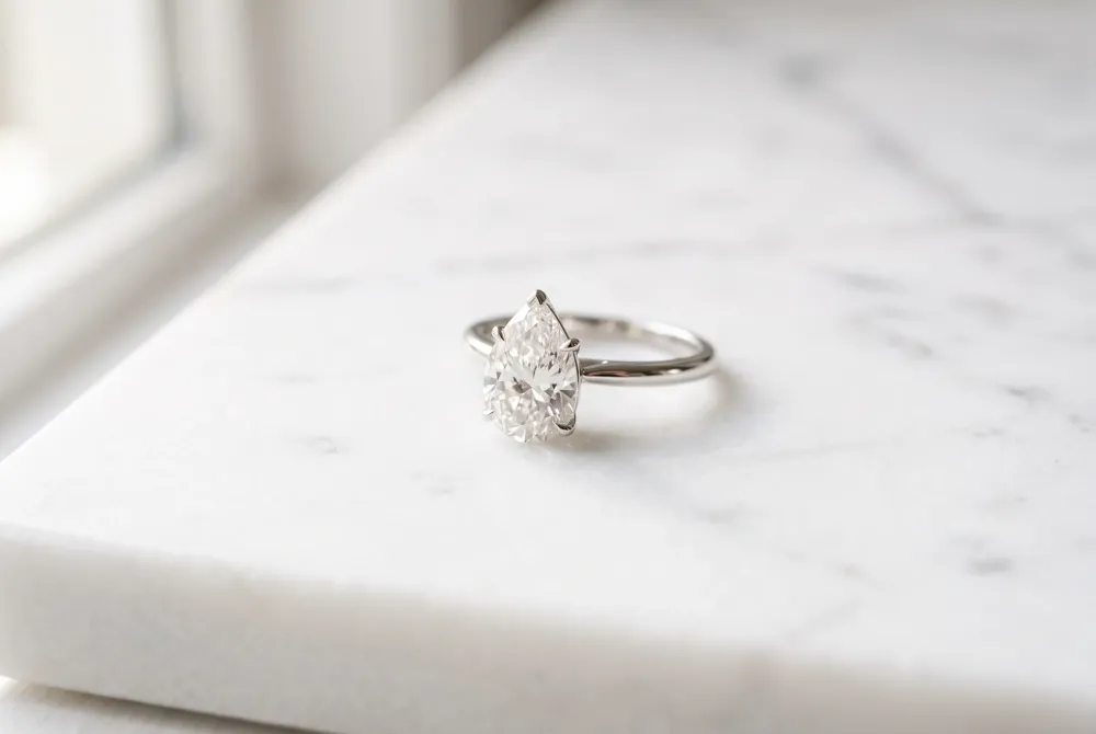 The solitaire teardrop ring offers a timeless and sophisticated silhouette that highlights the natural grace of a pear-cut diamond.