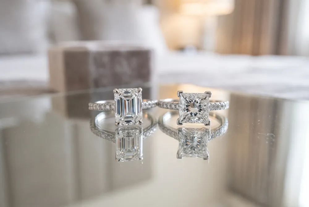 Emerald cut mirrors offer broad, deliberate flashes while princess cut facets scatter intense rainbow fire for two distinct personalities.