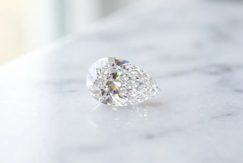 The teardrop silhouette of our curated pear-shaped diamonds serves as a timeless expression of emotional vulnerability and the beautiful, complex journey of a lifelong partnership.