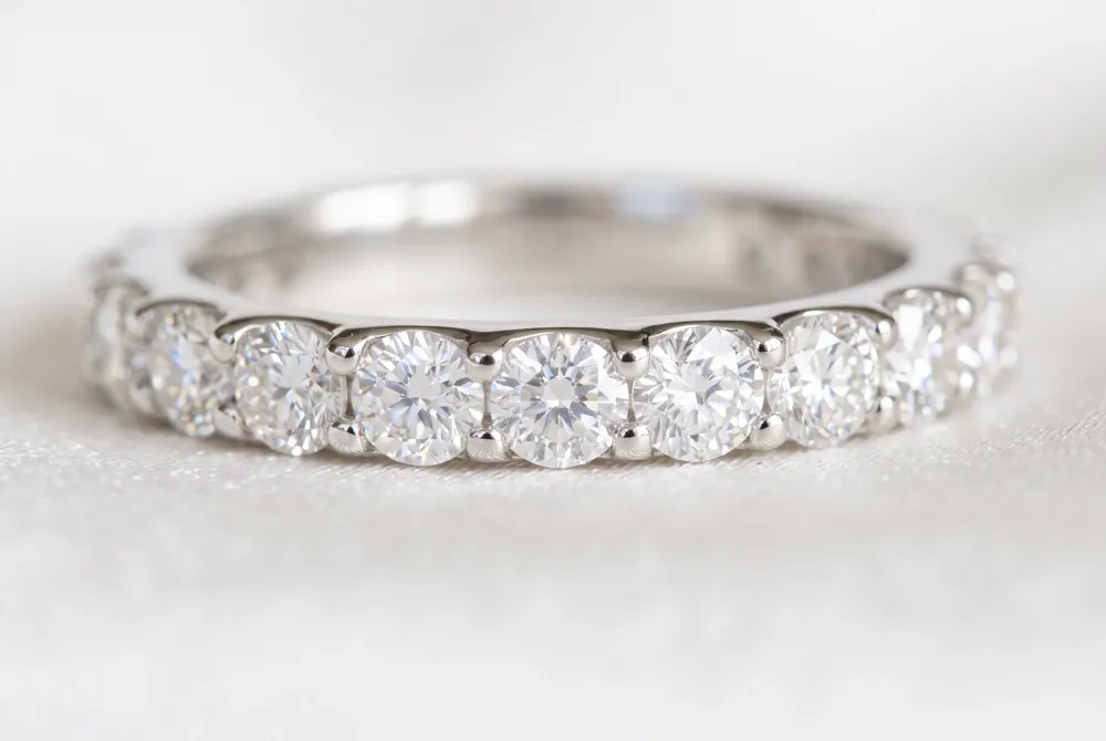 Pavé eternity bands create a continuous carpet of brilliance with small stones set closely together, delivering extraordinary sparkle and a luminous presence that enhances any engagement stack.
