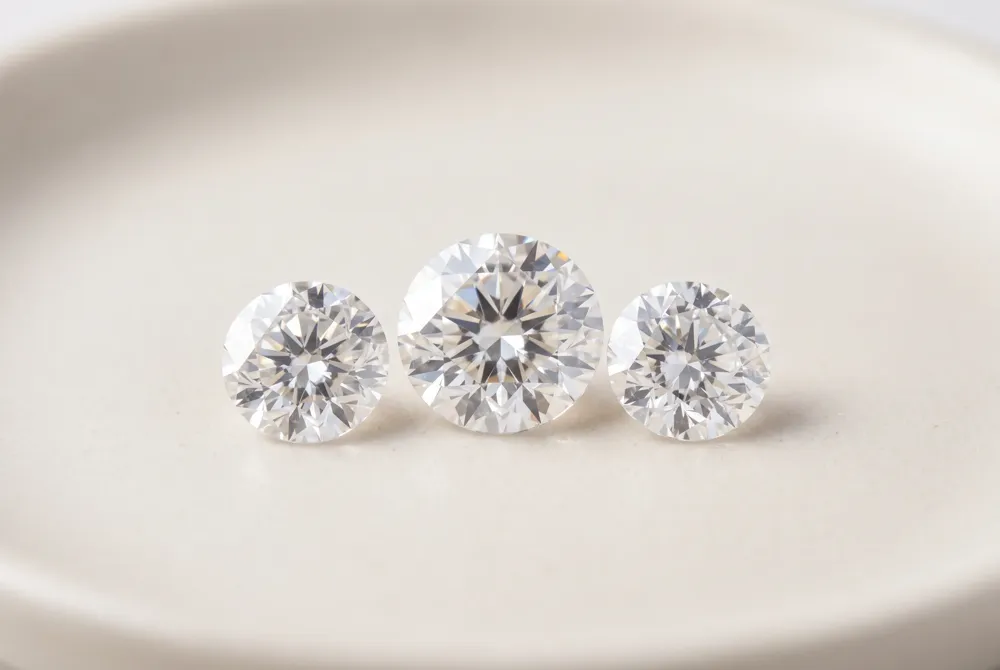The three-stone marquise pairs a center diamond with complementary side stones, creating a balanced composition that represents the past, present, and future of a relationship.