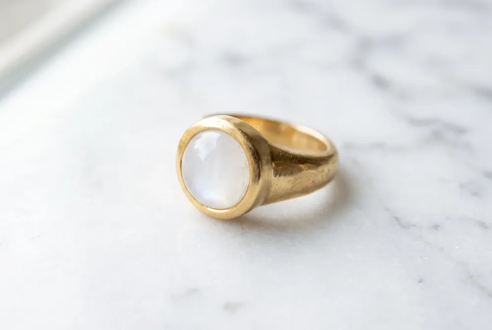 A single ring can serve as both engagement and wedding band when designed with a substantial shank and secure bezel, offering simplicity without sacrificing meaning.