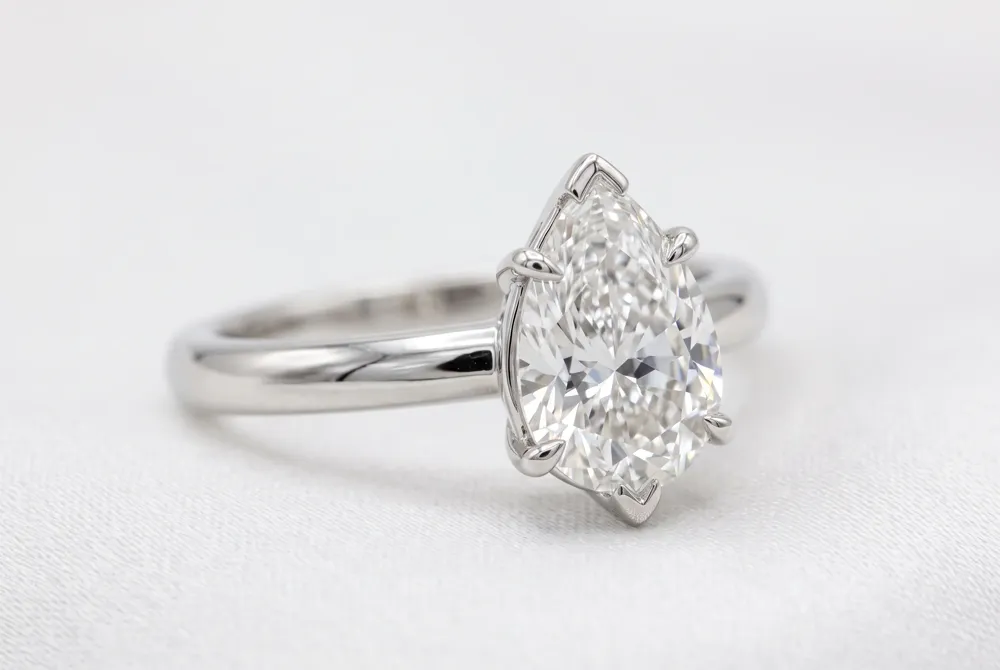 A classic solitaire setting lets your pear-shaped diamond command attention, with a delicate V-prong protecting its tip for lasting elegance and security.
