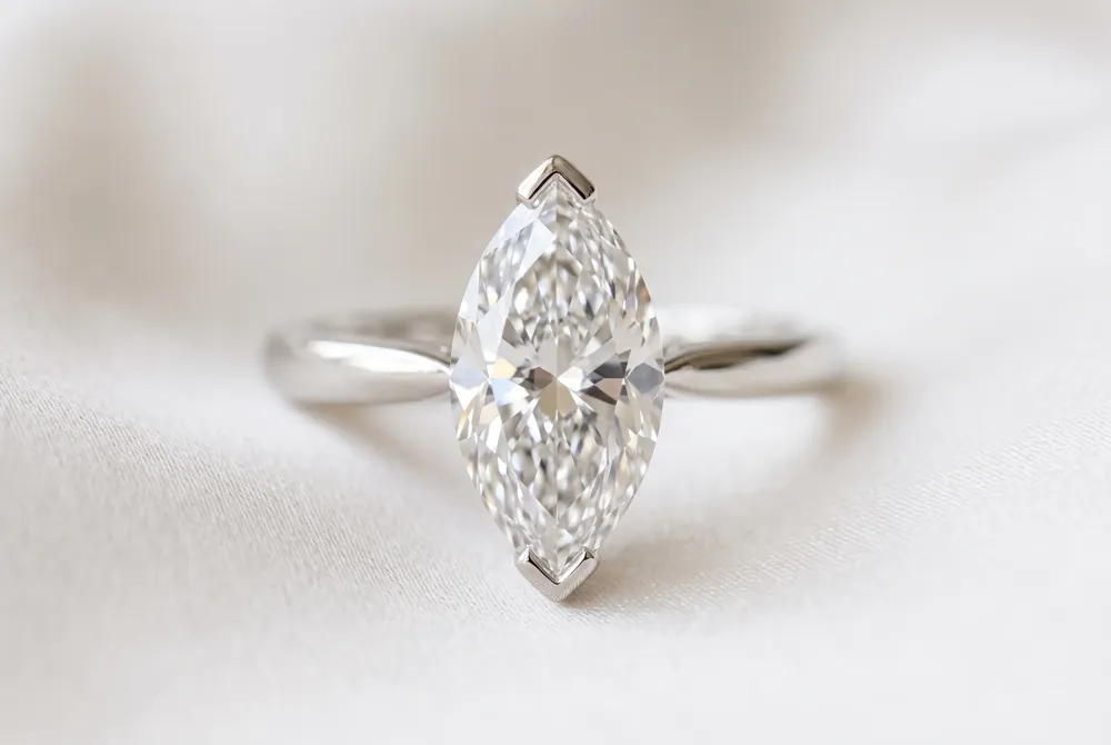 The solitaire setting lets a single marquise diamond command attention, its elongated silhouette made secure by V-prongs that protect the delicate pointed tips.