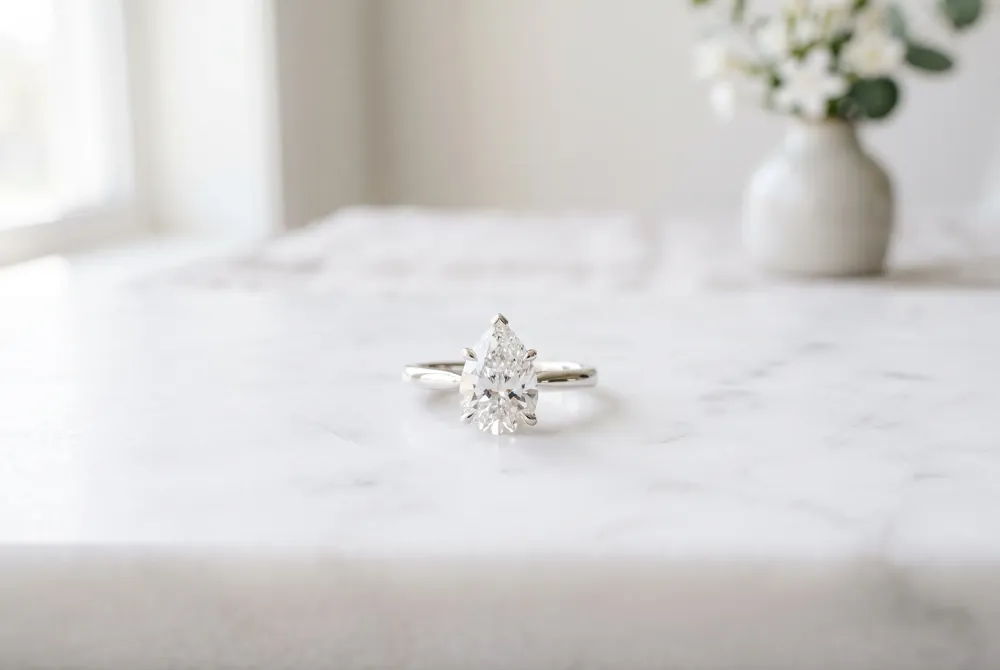 Experience the pure, unadorned beauty of the pear cut with our expertly crafted solitaire settings that highlight every facet of your diamond.
